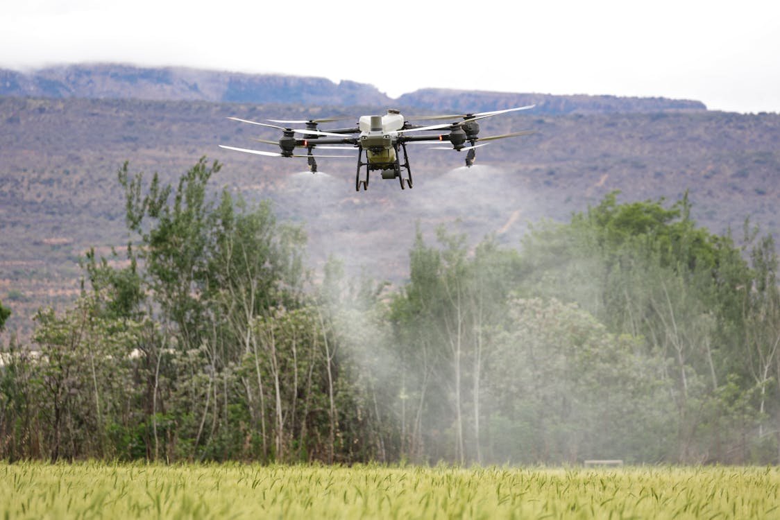Precision agriculture drone spraying a crop field